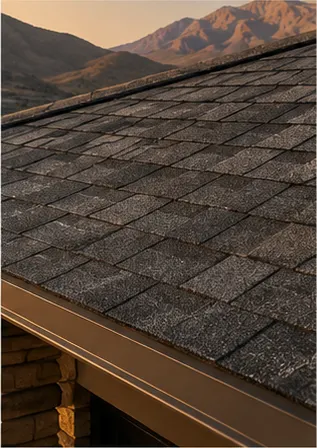 Close view of dark charcoal architectural shingles and a metal drip edge
