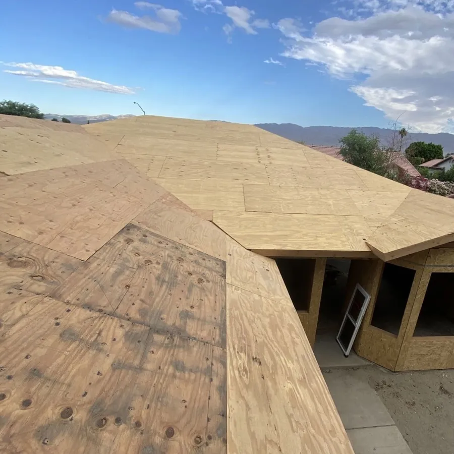 New plywood sheathing laid across a roof deck, ready for underlayment